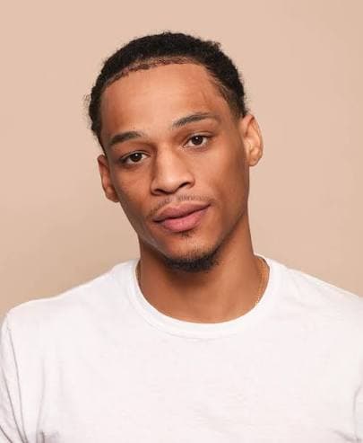 Shahid Hinton looking into the camera with a calm, confident expression